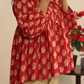 A woman wearing a red hand block printed cotton top with three-quarter sleeves and a round neckline.